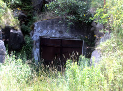 One of the caves where wine was stored is sealed behind a steel door.