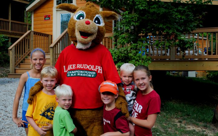 Rudolph with Kids in Front of Rudolph's Christmas Cabin