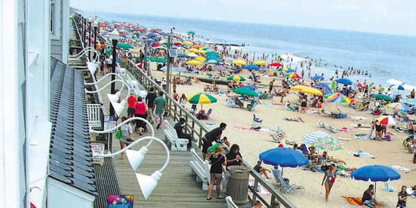 Vibrant umbrellas add a splash of color to a crowded beach.