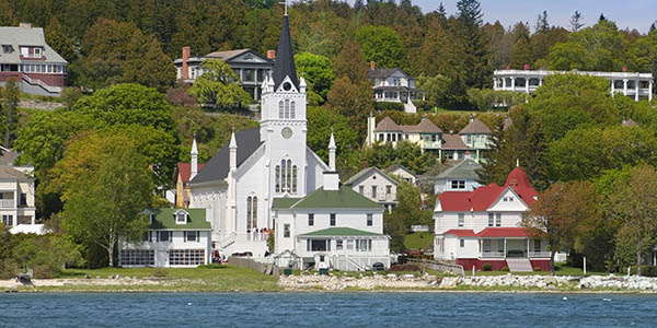 Stately houses line the shore of a large lake.