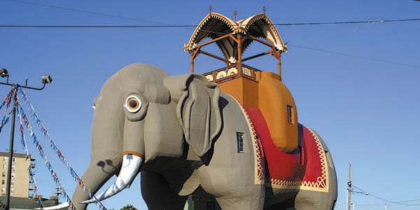 A statue of an Indian elephant with a canopy on top.