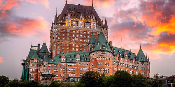 A massive, chateau-style hotel with green copper roov.