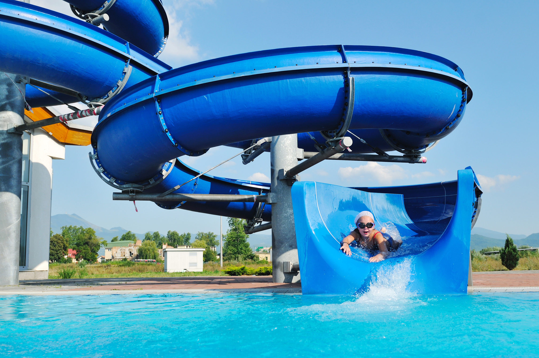 A kid about to shoot out of a curling waterslide.