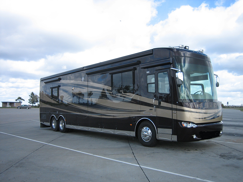 Large black and tan motorhome parked in parking lot