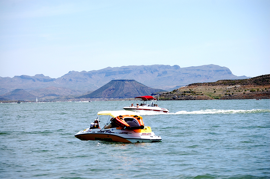 Boating in a lake amid a desert landscape.