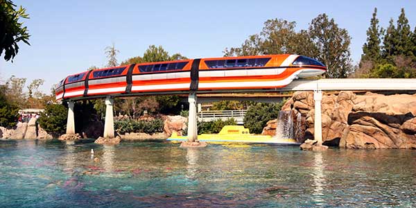 Monorail glides over lake.