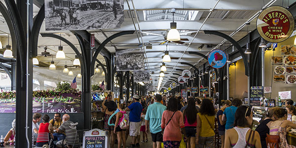 Shoppers and diners in a French Quarter market.