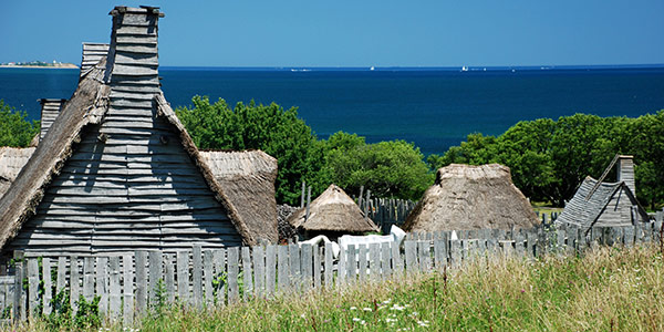 Rickety house on coast with blue ocean.