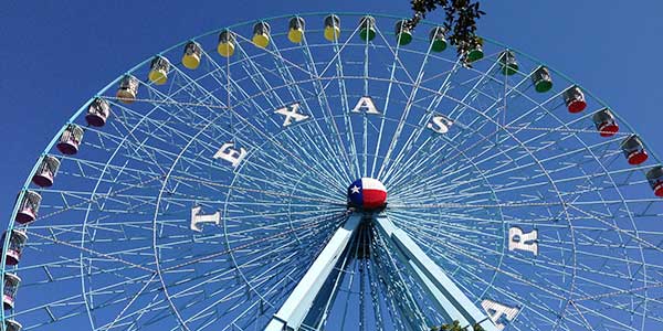 Ferris Wheel bearing letters spelling out "Texas Fair"