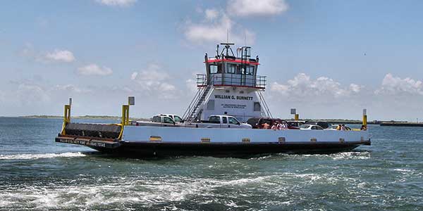 A small ferry carries a handful of vehicles.