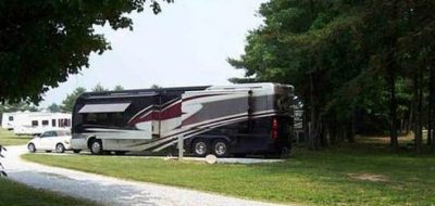 Large motorhome parked in RV site among trees