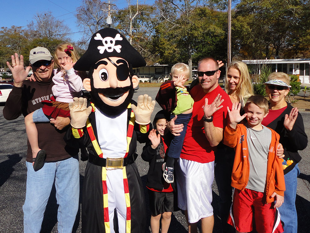 Pirateland Family Camping Resort - Family waving with Patch Thanksgiving