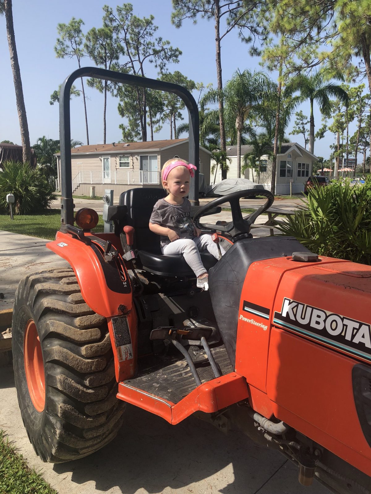 Woodsmoke Camping Resort - girl on tractor