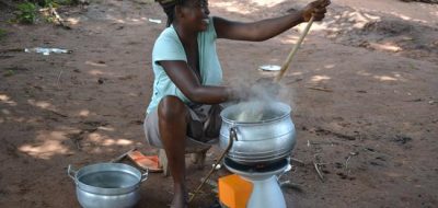Woman in Uganda using a BioLite home stove to cook.