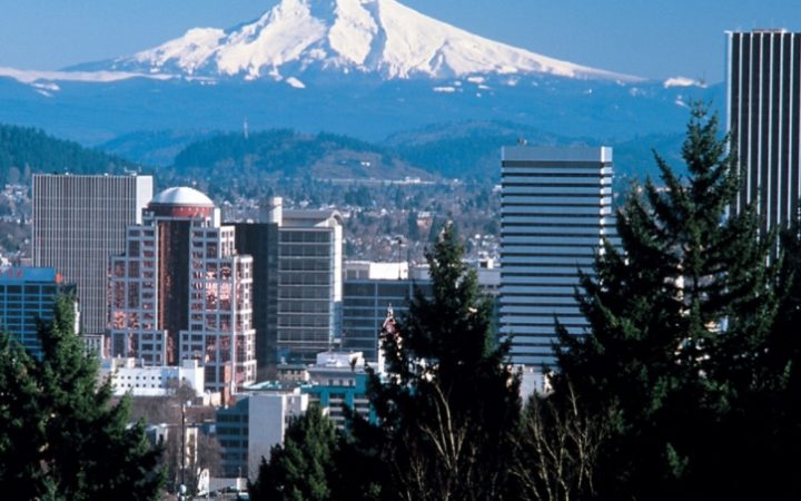 Portland downtown skyline with snow covered mountains in the background.