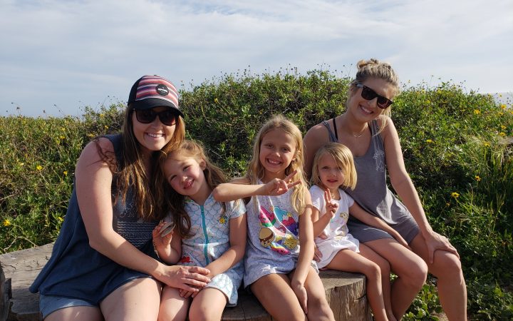 Group of little girls and their moms hanging out near the beach in Carpinteria, California.
