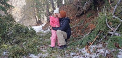 Father kissing daughter in the snow of Angeles Crest