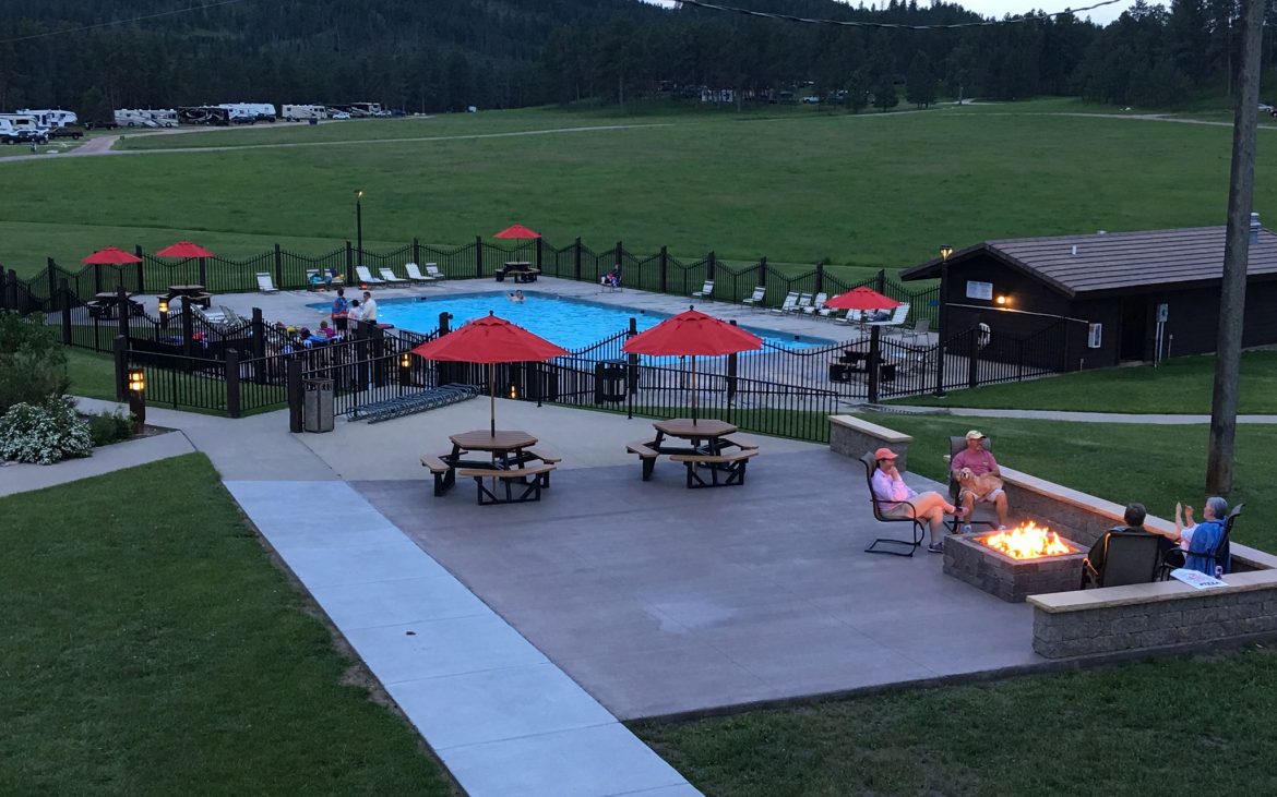 Outdoor patio setting with fire pit at dusk at Rafter J Bar Resort