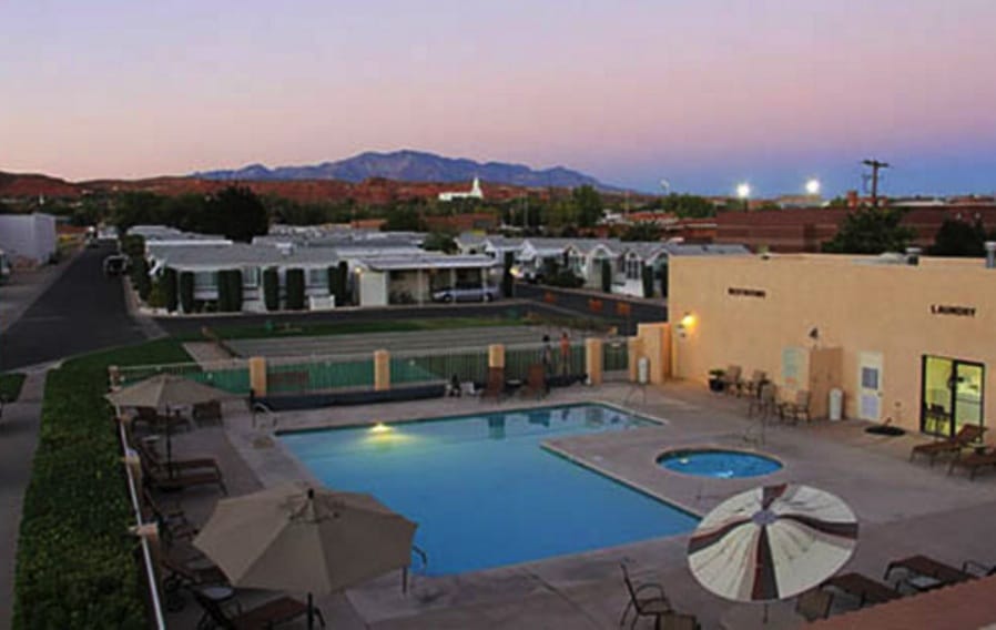 Aerial view of pool at RV resort with beautiful sunset and mountains in background
