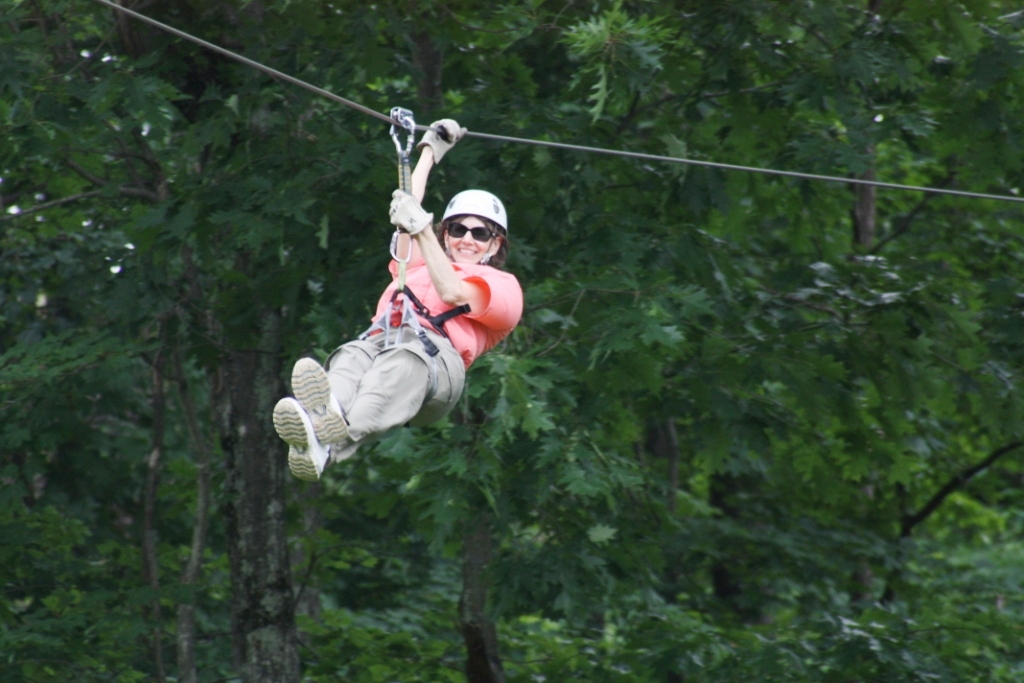 Camper zipping down a zipline