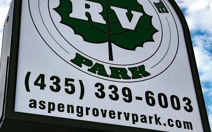 White and Black entry sign at Aspen Grove RV Park