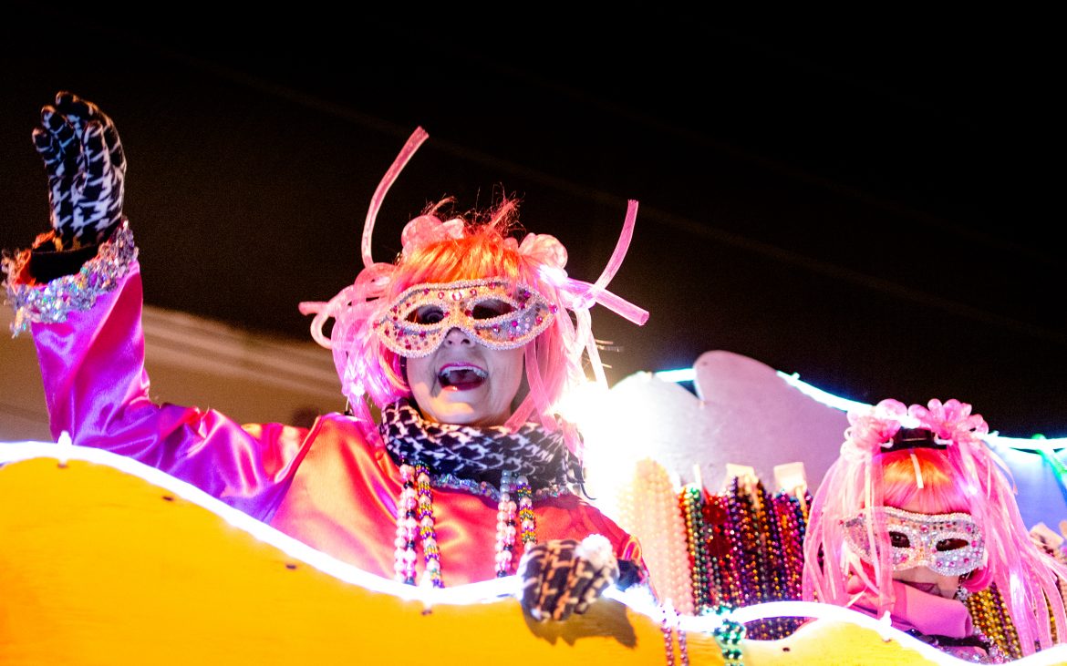 Man dressed up in neon light adororned costume during MArdi Gras parade