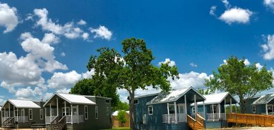 A pair of Sun RV Hill Country cottages under a blue Texas sky.