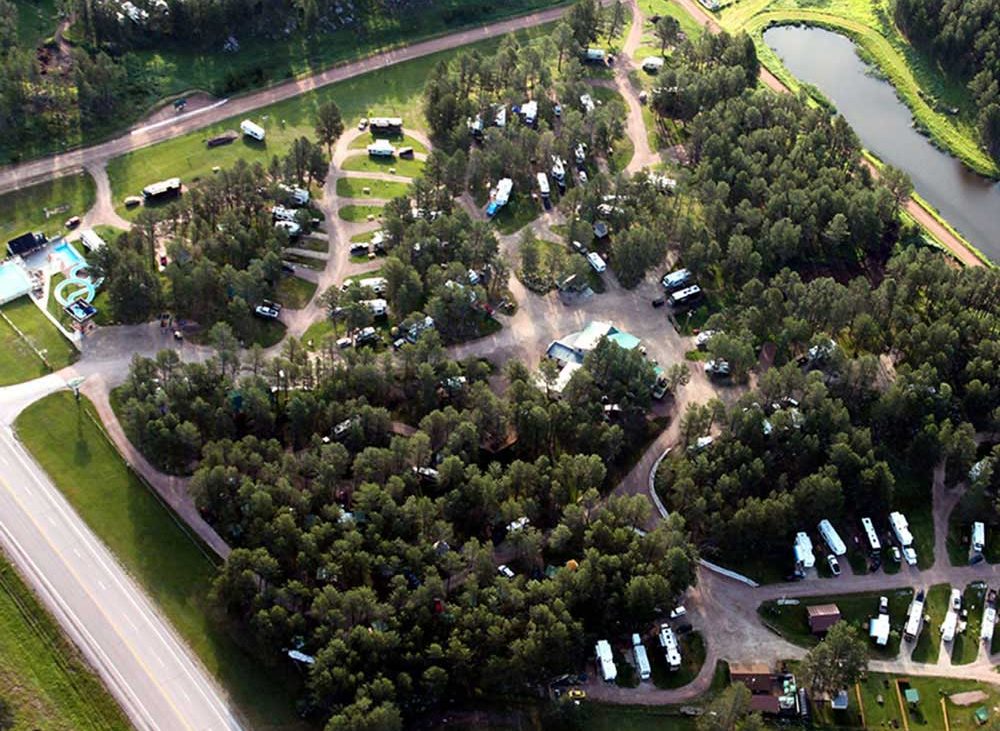 Breathtaking aerial view of Beaver Lake campground with lush trees and pond in background