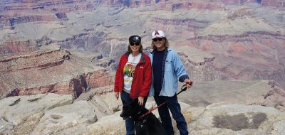 A couple with dog on the rim of the Grand Canyon.