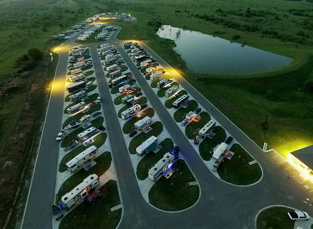 Twilight aerial view of many RVs parked in rows