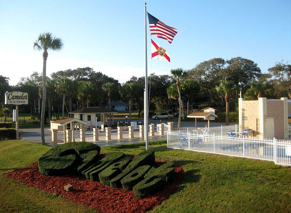 Camelot Park front entrance with flags and grassy sculptures