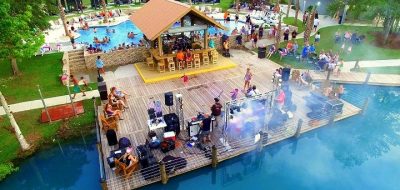 Colorful people performing on dock on pool