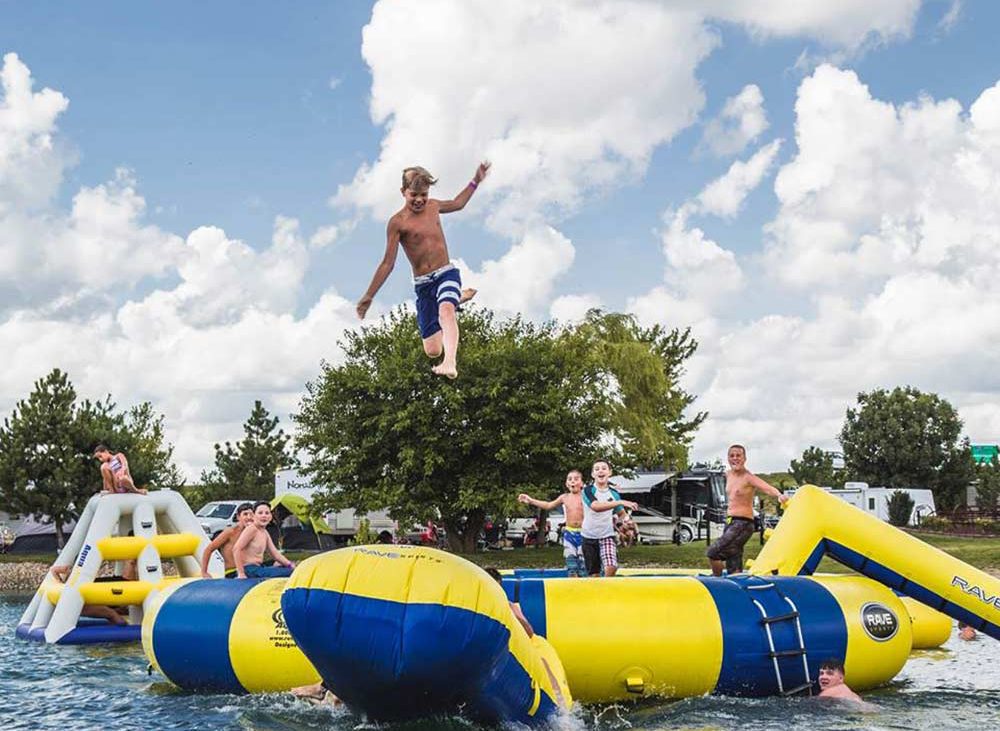 Boy jumping on water trampoline