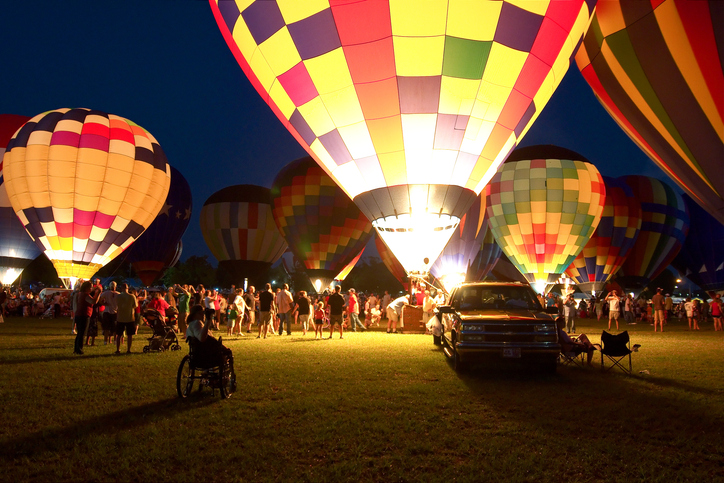 People prepare for the glowing of the balloons at the annual Hot Air Balloon Festival