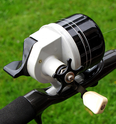 A black spincast reel.