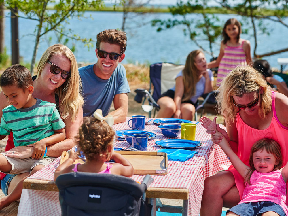 Large family at picnic table on the water