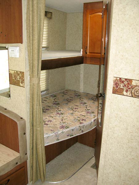 A fifth-wheel bunkhouse space with two beds.