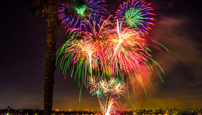 Colorful fireworks display over Newport Beach ocean at night