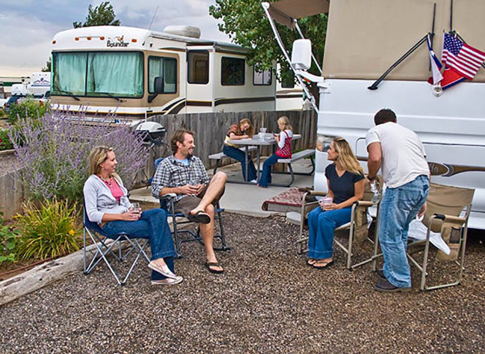 Campers relaxing in front of an RV