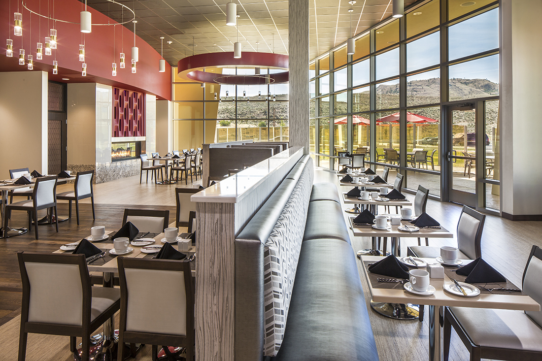 A restaurant overlooks scenic mountains and countryside.