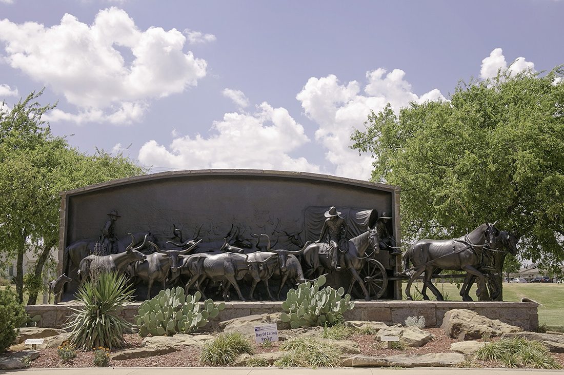 A sculpture depicts that challenges faced by cowboys in the 1800s.