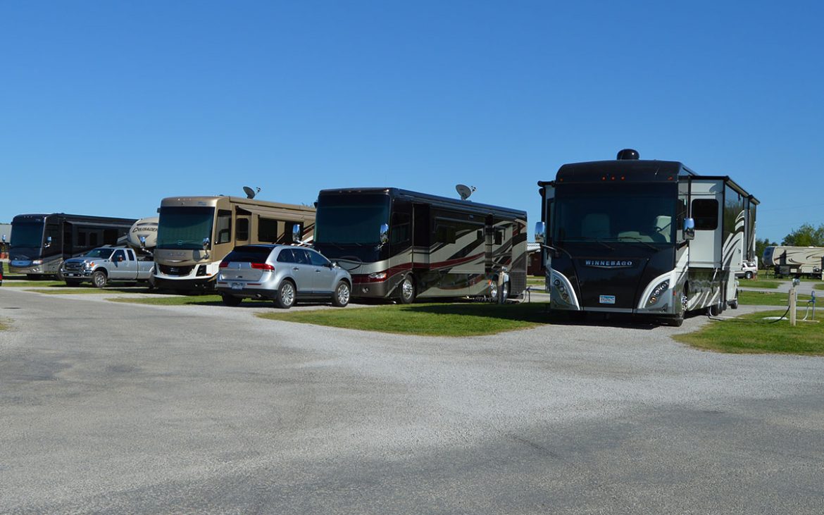 Large RVs lined up along paved road