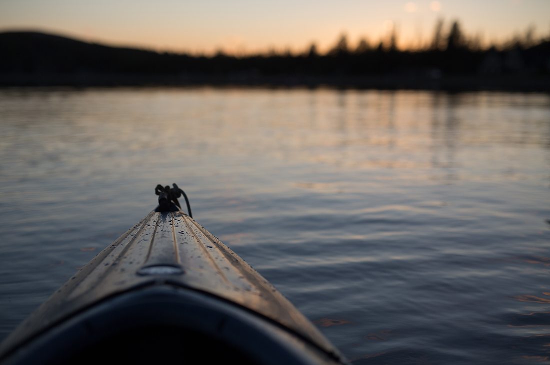 Pic of the bow of a kayak in placid water taken from the paddler POV.