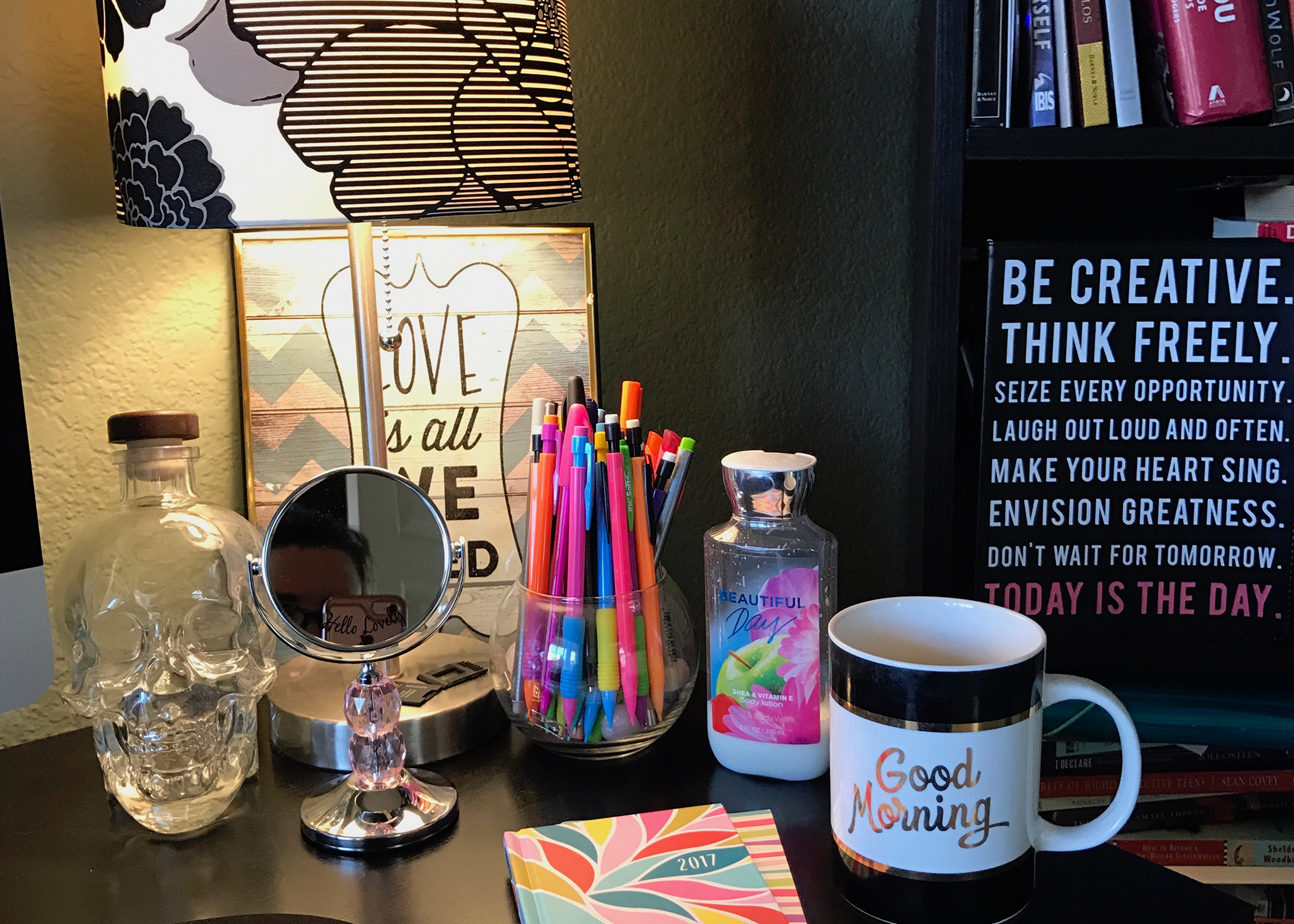 A desktop office cluttered with various knick knacks.
