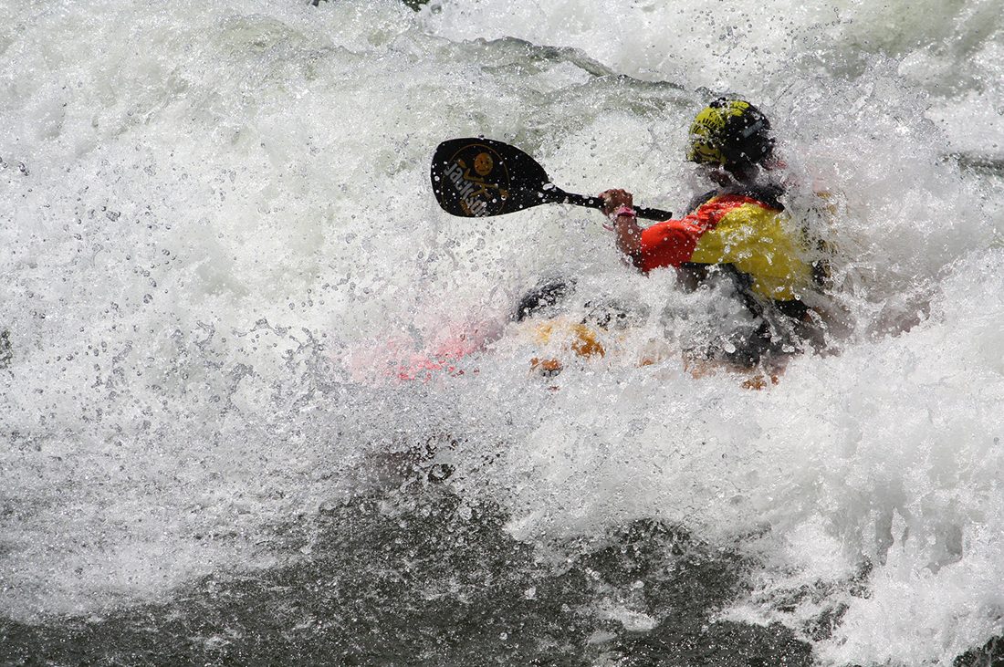 A kayaker gets overwhelmed by whitewater.