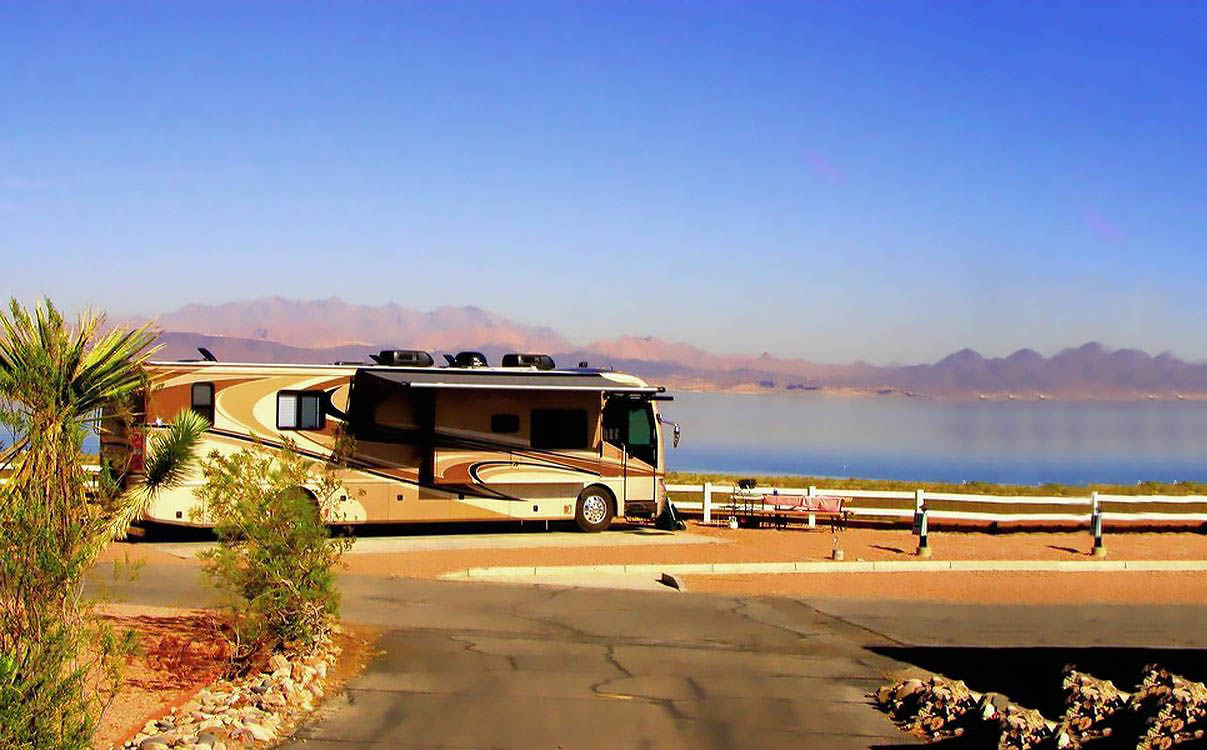A motorhome overlooks Lake Mead with mountains looming in the background.