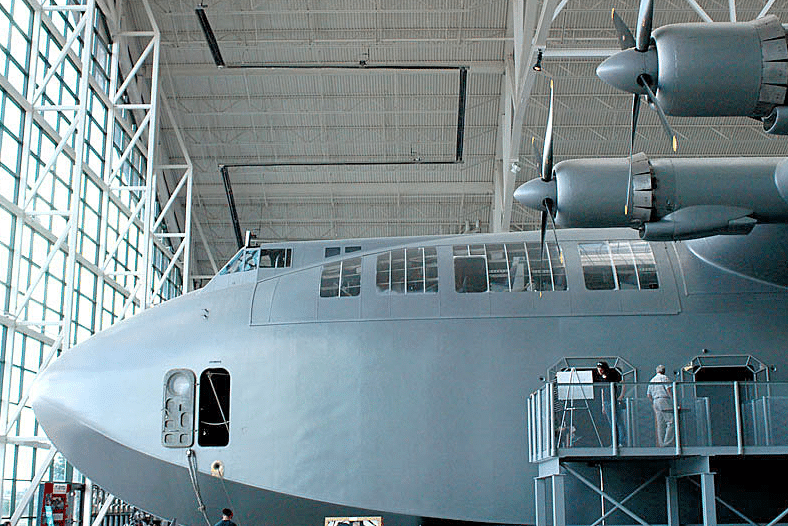 Huge WWII era cargo plane in a hanger.