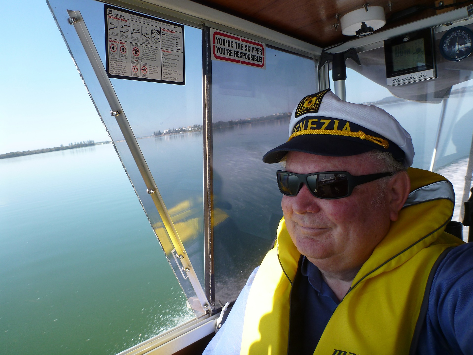 A 60-something man in a captain's hat takes the helm.
