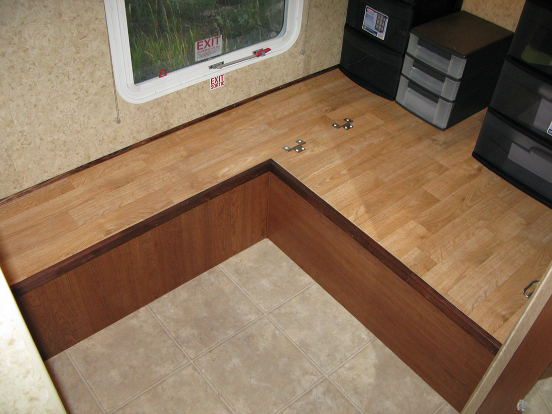 A storage space occupying the former bunkhouse space in a fifth-wheel.