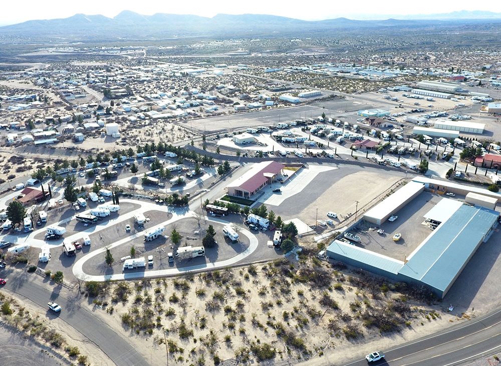 An aerial shot of an RV park with surrounding town.